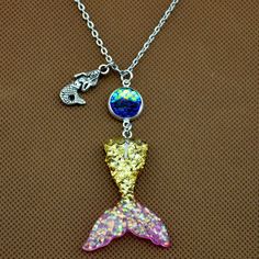 ♦ DESCRIPTION ♦ your Scale Color from a drop down menu. Mermaid Tail :33x41mm Scales: 12mm Chain measures about 22in Package: 1 Pcs The keychain packaged by OPP bag . Mermaid Tail Color: Pink blue blue &Pink Gold& Pink Purple&blue light purple Color of Scale(scales are 12mm) A:Clear B:light purple C:seaweed green D:Golden yellow E:ocean blue F:pink G:blue H:purple I:Silver gray J:Black K:blue purple L:Coffee Gold M:White All our items are NICKEL FREE and LEAD FREE. If you need more q Mermaid Charm Necklace With Lobster Clasp For Gift, Novelty Pink Jewelry With Lobster Clasp, Pink Novelty Jewelry With Lobster Clasp, Themed Gold Jewelry For Party, Novelty Necklace With Lobster Clasp For Gift, Themed Necklace With Lobster Clasp As Gift, Adjustable Necklace With Lobster Clasp For Birthday Gift, Pendant Charm Necklaces For Mother's Day Party, Novelty Purple Jewelry For Party