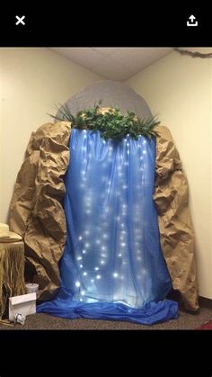 an artificial waterfall in the middle of a cubicle with lights on it's sides