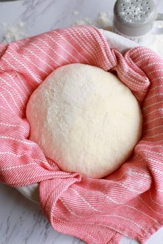 a ball of bread sitting on top of a pink towel