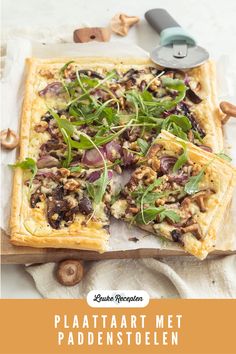 a pizza with mushrooms, spinach and other toppings