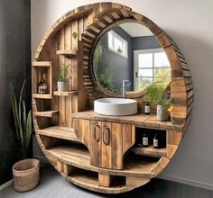 a bathroom with a circular mirror on the wall next to a wooden shelf and sink