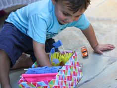 a young boy playing with a toy boat