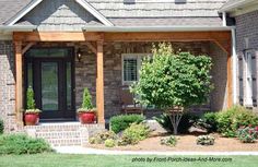 a brick house with green grass and trees