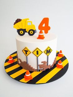 a birthday cake with construction vehicles on top