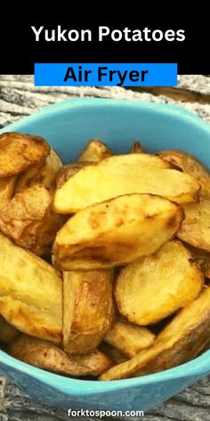 a blue bowl filled with fried potatoes on top of a wooden table