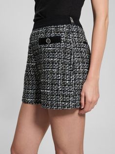 Woven boucle tweed shorts High rise, sits at natural waist Faux front pockets. Back welt pockets. Removable layered chain belt detail Denim waistband Side zip closure 3.25" inseam Measurements taken from a size S 70% Recycled Polyester, 12% Cotton, 9% Viscose/Rayon, 4% Polyamide/Nylon, 2% Metalized Fiber/Metallic, 2% Acrylic, 1% Wool. Contains recycled plastic. Chic Black Tweed Bottoms, Short Tweed Bottoms For Work, Chic Tweed Shorts, Spring Tweed Shorts, Casual Tweed Shorts, Tweed Shorts, Layered Chain, Viscose Rayon, Chain Belt