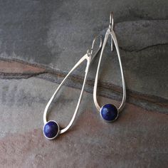 Lapis Lazuli teardrop dangle earrings. 8mm deep blue lapis set in sterling silver on handmade sterling silver teardrops. The teardrops swing from solid sterling silver ear wires. These earrings are 2 1/4 inches long including the ear wires. 5/8 inches at the widest part of the teardrop. For more Modern Nickel-free Drop Jewelry, Minimalist Teardrop Pierced Jewelry, Modern Hypoallergenic Teardrop Jewelry, Sterling Silver Teardrop Pendant For Pierced Ears, Modern Drop Earrings With Ear Wire, Modern Teardrop Earrings For Gift, Minimalist Teardrop Earrings With Matching Jewelry, Modern Pierced Dangle Teardrop Earrings, Nickel-free Long Drop Everyday Earrings