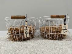 two wire baskets with tags on them sitting on the floor