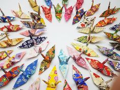 many colorful origami birds arranged in a circle