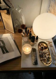 a table topped with lots of different types of hair brushes and other items on it