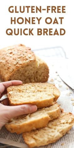 a person holding a loaf of gluten - free honey oat quick bread