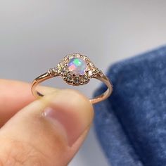 BASIC OPAL INFORMATION Round Opal : 5*5mm. Main stone: Natural good fire opal. Side stone: dainty cz diamond (cubic zircon). Material: 925 Sterling Silver +Natural opal stone. Metal color: silver, gold, rose gold. Metal materials: 925 sterling silver, 18K rose gold Plated, 18K rose gold Plated. SIMPLE DESIGN AND GOOD FIRE Delicate opal ring, that is perfect for stacking or wearing alone. A true beauty and must have! Sweet, simple, and dainty ring. Perfect for a minimalist look. They range from a Opal Halo Jewelry As Gift, Elegant Opal Birthstone Crystal Ring, Elegant Opal Crystal Ring With Birthstone, Elegant Opal Crystal Ring, Elegant Opal Gemstone Crystal Ring, Dainty Opal Diamond Ring, Elegant Opal Crystal Ring With Gemstone, Fine Jewelry Opal Ring With Cubic Zirconia, Opal Ring With Cubic Zirconia And Halo Setting