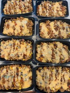 six trays filled with food sitting on top of a table