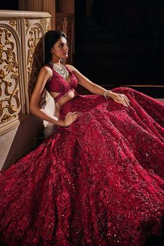 a woman in a red dress sitting on a bench