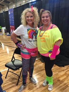 two women standing next to each other on a basketball court