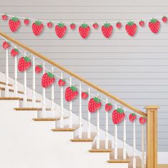 the strawberries are hanging on the string above the bannister and stair railing