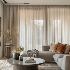 a living room filled with furniture and curtains