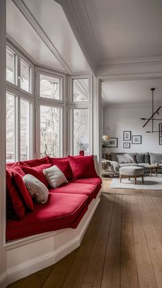 a living room filled with furniture and lots of windows