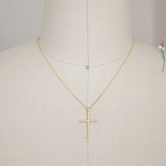 "Beautiful and lovely tiny gold color necklace featuring skinny gold cross pendent. Lobster clasp closure. Simple and warm. Gold plated brass necklace is perfect paired with any outfit . Your beautiful necklace will ship in a gift box. If you have any question, please feel free to contact me. Thanks :) ♥ Length 16\" chain ( if you need different length please contact us ) ♥ Cross pendent 1 1/4\" x 3/4\" ♥ Gold plated over brass ♥ Delivery Time Fast shipping within 1 - 3 days + See more Rudiana A Minimalist Gold Cross Necklace, Gold Delicate Cross Charm Necklaces, Delicate Gold Cross Charm Necklaces, Simple Gold Cross Pendant Necklace, Gold Crucifix Charm Necklace In Minimalist Style, Gold Cross Necklace With Delicate Chain For Everyday, Gold Minimalist Crucifix Charm Necklace, Everyday Gold Cross Necklace With Delicate Chain, Minimalist Gold Crucifix Charm Necklace