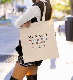 "Monaco Monte Carlo Canvas Tote Bag , these cute and aesthetic cotton tote bags are very trendy and practical for everyday use. They make a great shopping , picnic , beach bag , or as an everyday fashion accessory, and makes a great gift for friends and family. ★ 100% cotton Canvas ★ One size  ★ Heavy fabric  ★ Measuring at 16\"h x 15\"w and with a handle length of 20\" ★ Reinforced handle stitching ★ Sustainable, practical and durable ★ Please Note : White space does not print , it will be left blank instead. ★Tote bag handle is shorter than displaced in pictures, please refer to size above." Summer Canvas Bag With Large Capacity, Summer Large Capacity Cotton Canvas Bag, Large Capacity Cotton Bag For Beach Season, Trendy Summer Cotton Bags, Casual Beach Bag With Letter Print For Daily Use, Cotton Canvas Bag For Daily Use And Beach Season, Cotton Beach Bags For Daily Use, Trendy Cotton Canvas Bag For Summer, Summer Large Capacity Cotton Beach Bag