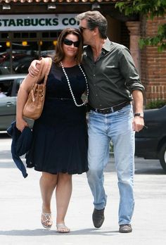 a man and woman walking down the street