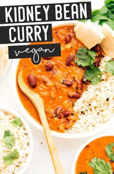 two bowls filled with kidney bean curry next to rice and cilantro