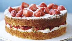 a cake with strawberries on top is sitting on a plate