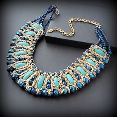 A vintage blue bib necklace is a statement piece for any occasion. Metal: gold-tone Stone - blue stone and glass beads Size -  '' + extender chain Signed - Kaymen Around the  2000s Condition - good condition PLEASE NOTE: Vintage jewelry can show signs of wear and discoloration or chipped metal consistent with age. Please look at the pictures carefully. Most were purchased at estate sales, auctions, etc. so they could need cleaning. If you need additional pictures or have questions, please contact me prior to purchase. I am not a jeweler or an expert. I do the best I can to research and represent the items. Also on auction purchases, I use the information I get from the auction houses. If you have any questions or need additional pictures, please let me know. Jewelry is sent first class in Metal Choker Bib Necklace In Costume Jewelry Style, Metal Choker Bib Necklaces For Costume Jewelry, Elegant Blue Chain Necklace For Party, Costume Jewelry Beaded Choker Necklace, Gold Bib Necklace With Colorful Beads, Vintage Blue Choker Jewelry, Beaded Metal Bib Necklace In Costume Jewelry Style, Beaded Metal Bib Necklaces In Costume Jewelry Style, Beaded Metal Bib Necklace For Costume Jewelry