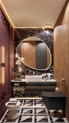 the bathroom is decorated in black, white and gold with an oval mirror on the wall