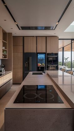 a modern kitchen with an island countertop and glass top oven hoods in the center