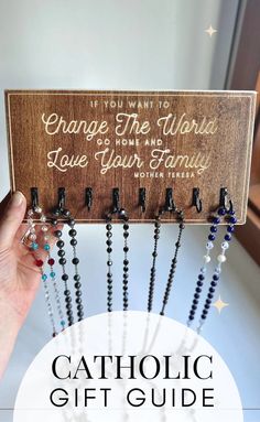 the catholic gift guide is shown with rosarys hanging from it's holder and text that reads, orange the way to love your family