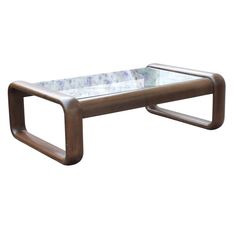 a coffee table with a glass top and metal frame on the bottom, against a white background