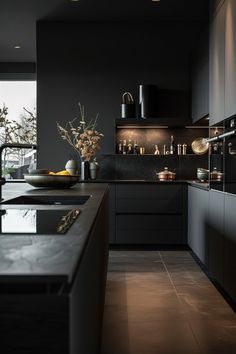 a modern kitchen with black cabinets and counter tops, along with an island in the middle