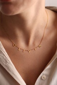 ✦ 𝐈𝐭𝐞𝐦 𝐃𝐞𝐬𝐜𝐫𝐢𝐩𝐭𝐢𝐨𝐧 "Discover timeless elegance with our 14k, 18k, and 22k Gold Plated Custom Letter Necklace by Pashicreations. Personalized to perfection, this name necklace is the epitome of minimalist charm, ideal for everyday wear. Delight Mom with a dainty yet meaningful gift in both gold and silver options. Elevate her style with our simple yet stunning custom earrings, meticulously handmade for that extra touch of uniqueness. Whether it's a cherished anniversary, a heartfel Everyday Yellow Gold Custom Name Necklace, Yellow Gold Custom Name Necklace For Everyday, Delicate Everyday Jewelry With Custom Name, Minimalist Gold Name Necklace, Custom Name Necklace For Anniversary, Minimalist Style, Minimalist Custom Name Necklace For Anniversary, Simple Yellow Gold Necklace As Gift, Minimalist 14k Gold Name Necklace For Anniversary, Minimalist Customizable Yellow Gold Necklace