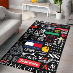 a living room area rug with various types of logos and colors on it, in front of a couch