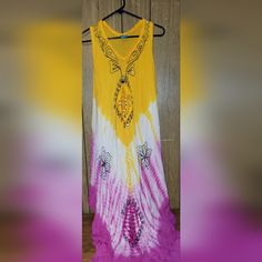 Bohemian Style. Handkerchief Hem. Sleeveless. Embroidered. Tie Dyed Bohemian Embroidered Sleeveless Sundress, Bohemian Tie Dye Sleeveless Sundress, Sleeveless Tie Dye Bohemian Dress, Bohemian Sleeveless Tie Dye Dress, Yellow Bohemian Dress With Batik Print, Purple Sleeveless Bohemian Sundress, Tie Dye Bohemian Sundress, Tie Dye Cotton Sleeveless Dresses, Tie Dye Sleeveless Cotton Dress