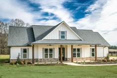 a white house sitting in the middle of a field