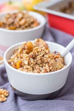 two bowls filled with granola on top of a table