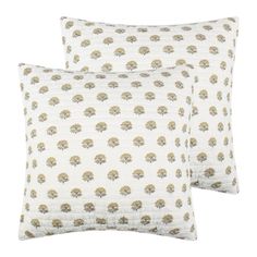 two pillows with trees on them, one is white and the other has gold leaves