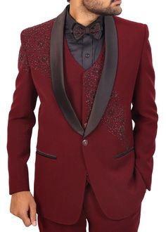 Maroon Hand Embroidered tuxedo suit includes everything you need for a polished and put-together look. It consists of a jacket, vest, pants, shirt, and a matching bowtie. The classic 2-button jacket features a tailored fit, ensuring a sharp silhouette and a touch of modern flair. The suit is made from a rich maroon polyester fabric that not only looks regal but also feels incredibly comfortable against your skin.  Whether you're attending a wedding, a black-tie event, or a formal dinner, this tuxedo suit is versatile enough to suit any occasion.  The set includes black dress shirt and a matching bowtie to complete your ensemble. The trousers feature a classic design with a traditional bottom, offering a timeless look and comfortable wear. This Men's Stylish 2-Button Tuxedo Suit is designed Festive Tuxedo Three-piece Suit For Ceremony, Red Formal Party Wear Sets, Luxury Fitted Suit For Festive Occasions, Festive Three-piece Suit With Notch Lapel For Party, Tailored Sets For Groom's Festive Celebration, Tailored Sets For Groom At Festive Occasions, Tailored Sets For Groom In Festive Occasions, Festive Tailored Sets For Groom, Festive Notch Lapel Three-piece Suit For Parties