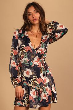 Lulus Exclusive! Celebrate the day and do it in style with the Lulus So Splendid Navy Blue Floral Satin Long Sleeve Wrap Dress! Sleek woven satin (with a lovely mauve and ivory floral print) sweeps across a darted, wrapping bodice and long sleeves with gathered shoulders and elastic cuffs. Two ties secure the high waist above a wrapping A-line skirt with a ruffled mini hem. Fit: This garment fits true to size. Length: Mid-thigh. Size small measures 34.5" from shoulder to hem. Bust: Great for any Floral Print Dress For Date Night In Fall, Floral Print Dress For Fall Date Night, V-neck Floral Dress For Date Night, Long Sleeve Floral Print Dress For Date Night, Long Sleeve Floral Dress For Date Night, Elegant Printed Floral Dress For Brunch, Chic Printed Floral Dress For Brunch, Floral Print Long Sleeve Rayon Dresses, Long Sleeve Floral Print Rayon Dresses