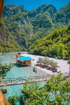 the beach is surrounded by mountains and blue water