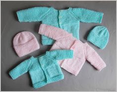 three knitted baby sweaters and two hats, one pink and the other blue