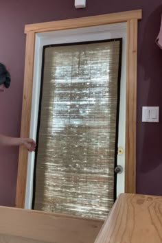 a woman is standing in front of a window with blinds on the outside and inside