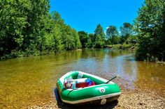 an inflatable boat on the shore of a river