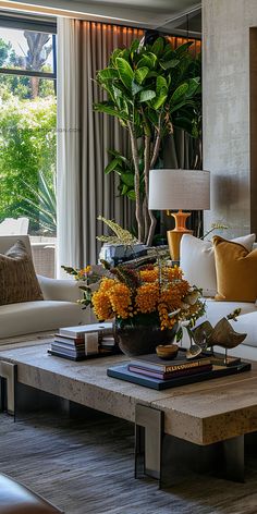 a living room filled with lots of furniture and flowers on top of a coffee table