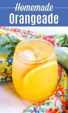 a glass filled with lemonade sitting on top of a table