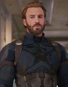 captain america the winter soldier is looking into the distance with his beard and chest armor on