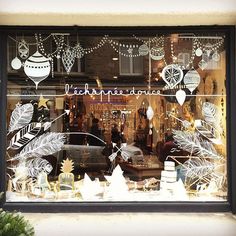 a store front window with christmas decorations in it