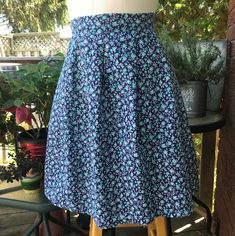 Well made home sewn elastic waist skirt/ Dirndl type skirt-   Calico print teal & lavender flowers with navy background polyester cotton blend. Elastic back waistband Front pleats. Side inset pockets. Waist: 32" Length: 23 1/2" A  cool and very pretty summer skirt! I offer a 15% discount if you buy 2 items. Code: 15OFF2               20% discount if you buy 3 items. Code: 20OFF3               25% discount if you buy 4 items. Code: 25OFF4 Please message with any questions. Calico Print, Sewing Elastic, Elastic Waist Skirt, Navy Background, Blue Floral Print, Summer Skirts, Lavender Flowers, Print Skirt, Printed Skirts